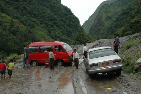 Red school van stuck in the mud